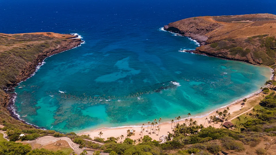 Crystal-clear waters and coral reefs of Hanauma Bay, Oahu, popular for snorkeling with tropical fish and sea turtles.