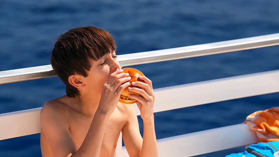 Papi's Ohana family having a burger for lunch on Pride of Maui's 'Elua