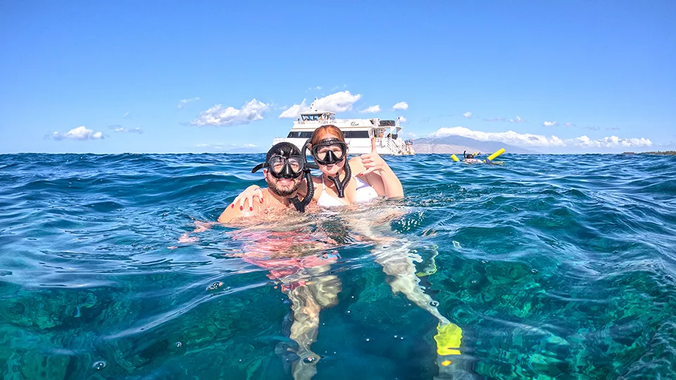 Papi's Ohana team members smiling in the water on a snorkel cruise with Pride of Maui 'Elua