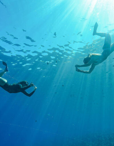 Two Guests Snorkeling Underwater Near Molokini