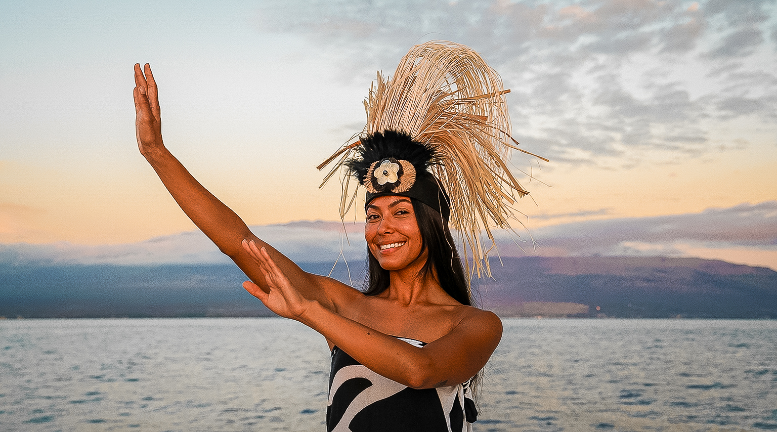 Hawaiian hula dancer performing on deck at sunset during the Pride of Maui Dinner Cruise