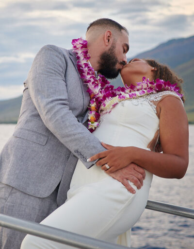 Bridal Couple Kissing on a Pride of Maui Wedding Cruise