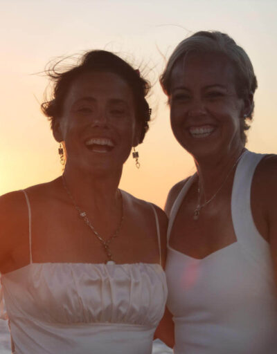 Couple Smiling with Sunset in Background on a Pride of Maui Wedding Cruise